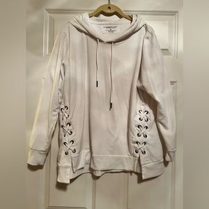 Cream sweatshirt with hood. Crossties on each side.